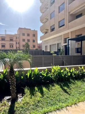 a palm tree in front of a building at Palmeraie Gates 2 chambres Piscine et Parking in Marrakech