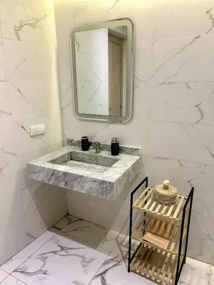 a bathroom with a sink and a mirror at Palmeraie Gates 2 chambres Piscine et Parking in Marrakech