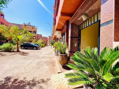 a street with a car parked next to a building at Cycas Family aparts 1 ch salon parking in Marrakech
