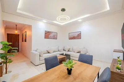 a living room with a table and a couch at New! Modern 2BR Guéliz Center, Station & M-Avenue in Marrakech