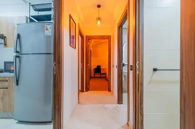 a hallway leading to a kitchen with a refrigerator at New! Modern 2BR Guéliz Center, Station & M-Avenue in Marrakech