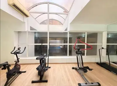 a gym with three exercise bikes in a room at Maison LINA in Marrakech