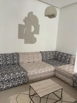 a living room with a couch and a table at Villa 5 suites piscine privée in Marrakech
