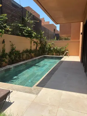 a swimming pool in the side of a building at Villa 5 suites piscine privée in Marrakech
