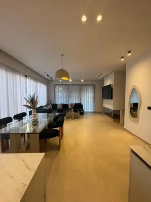 a large living room with a table and a couch at Villa 5 suites piscine privée in Marrakech