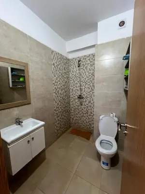 a bathroom with a toilet and a sink at Appartement bien équipé avec piscine sur Marrakech in Marrakech