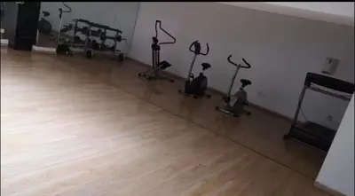 a gym with exercise bikes in a room with a wooden floor at Cosy escape 1BED in central Gueliz With Pool in Marrakech