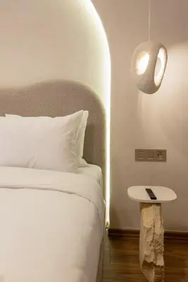 a bedroom with a bed with a table and a lamp at Cosy escape 1BED in central Gueliz With Pool in Marrakech