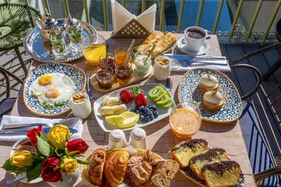 a table with breakfast foods and drinks on it at Riad Janate BAHIA & Spa in Marrakech