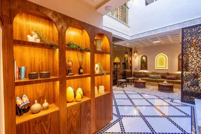 a lobby with wooden walls and shelves with vases at Riad Janate BAHIA & Spa in Marrakech