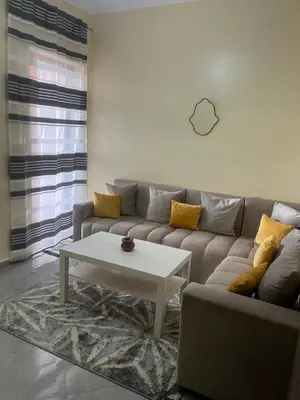 a living room with a couch and a coffee table at Appartement très bien meublé in Marrakech