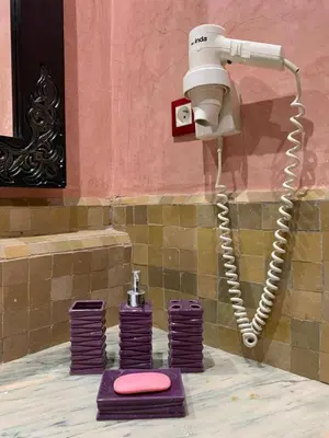 a security camera in a bathroom with purple towels at le pavillon de la palmeraie - Piscine et jardins in Marrakech