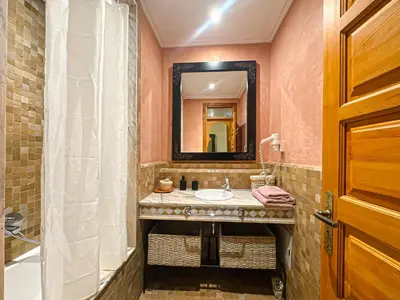 a bathroom with a sink and a mirror at le pavillon de la palmeraie - Piscine et jardins in Marrakech