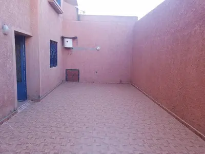 an empty room with a pink wall and a door at charming place in Marrakech