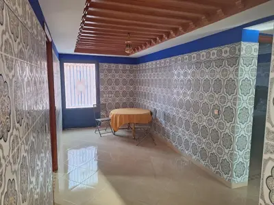 a room with a table and a wall with blue at charming place in Marrakech