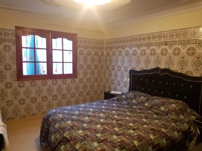 a bedroom with a bed and a window at charming place in Marrakech
