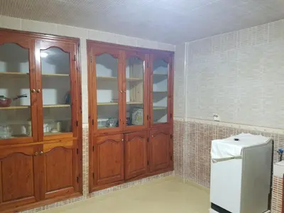 a kitchen with wooden cabinets and a refrigerator at charming place in Marrakech
