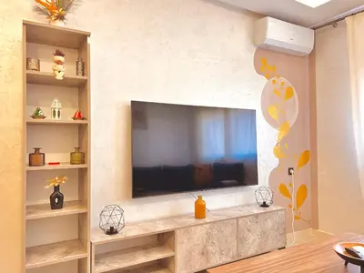 a living room with a flat screen tv on a wall at Appartement Chic près M Avenue Piscine Balcon in Marrakech