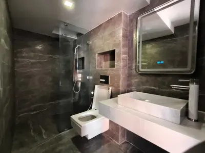 a bathroom with a white sink and a toilet at Duplexe Moderne 3 suites à Oliver Palm Resort in Marrakech