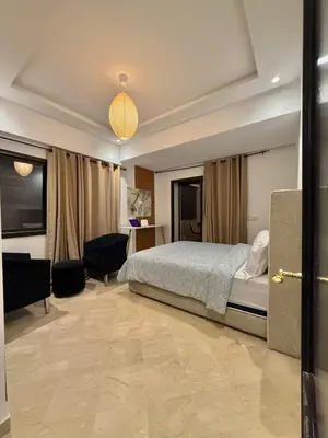 a bedroom with a bed and a room with a desk at Premium Stay in a Prestigious Residence with a Pool in Marrakech