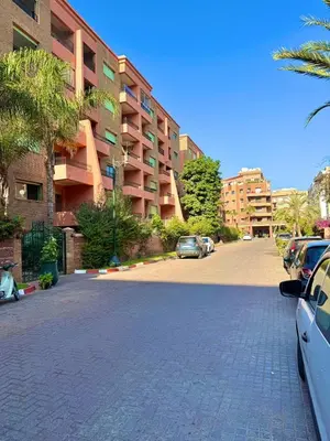 a parking lot with cars parked in front of a building at Premium Stay in a Prestigious Residence with a Pool in Marrakech