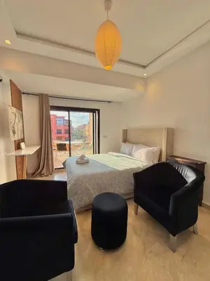 a bedroom with a bed and a couch and a chair at Premium Stay in a Prestigious Residence with a Pool in Marrakech
