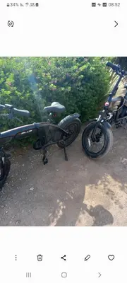 a bike parked in a parking lot next to some bushes at Madam Laila house in Marrakesh in Marrakech