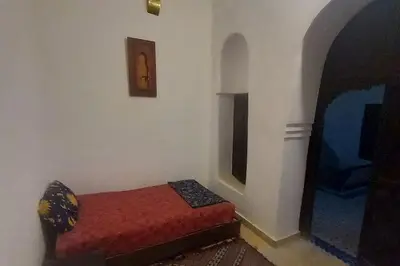 a room with a bed in the corner of a room at Madam Laila house in Marrakesh in Marrakech