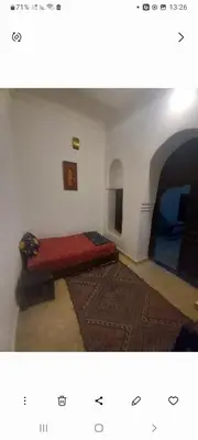 a bedroom with a bed in the corner of a room at Madam Laila house in Marrakesh in Marrakech