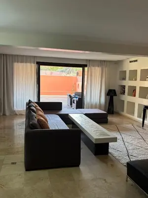 a living room with two couches and a table at Appartement centre Marrakech avec piscine in Marrakech