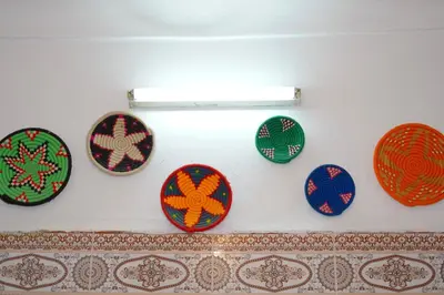 a bunch of plates hanging on a wall at Riad Dar Ceramic in Marrakech