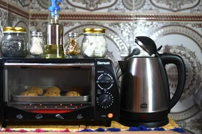 a toaster oven with muffins inside of it at Riad Dar Ceramic in Marrakech