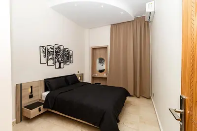 a bedroom with a black bed in a room at Karim Miloudi in Marrakech