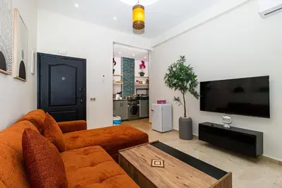 a living room with a couch and a flat screen tv at Karim Miloudi in Marrakech