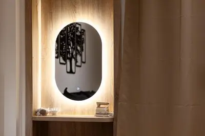 a bathroom with a round mirror on a shelf at Karim Miloudi in Marrakech