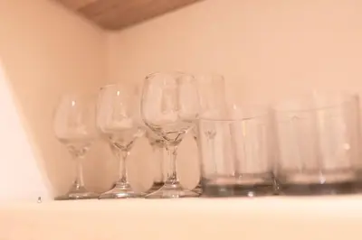 a row of wine glasses sitting on a shelf at Karim Miloudi in Marrakech