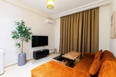 a living room with a couch and a tv at Karim Miloudi in Marrakech