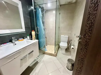 a bathroom with a shower and a sink and a toilet at Rosa High standing apartment in Marrakech