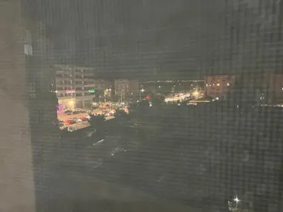 a view of a city at night from a window at Rosa High standing apartment in Marrakech