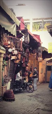 a man sitting on a scooter in front of a shop at Freedom Yan Hostel in Marrakech