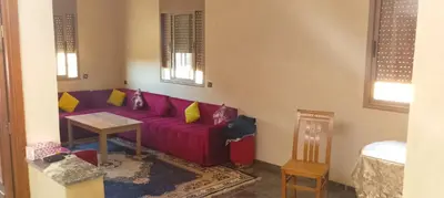 a living room with a purple couch and a table at Belkadi in Marrakech