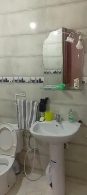 a bathroom with a sink and a toilet and a mirror at Belkadi in Marrakech