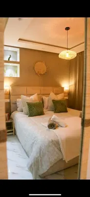 a dog laying on a bed in a bedroom at Victor Hugo Prestige Suite in Marrakech
