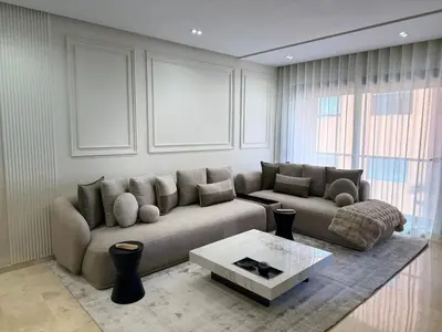 a living room with a couch and a coffee table at Appartement moderne en plein Gueliz in Marrakech