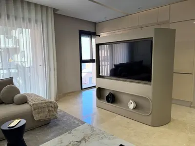 a living room with a large flat screen tv at Appartement moderne en plein Gueliz in Marrakech