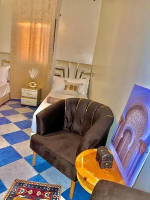 a living room with a couch and a bed at Marrakech airport in Marrakech