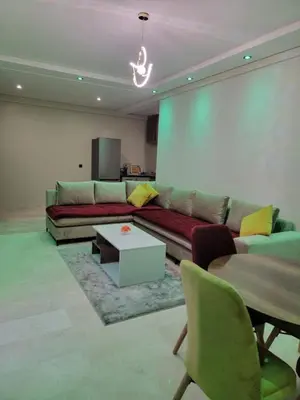 a living room with a couch and a table at Nour prestige Appartement Piscine free Parking in Marrakech
