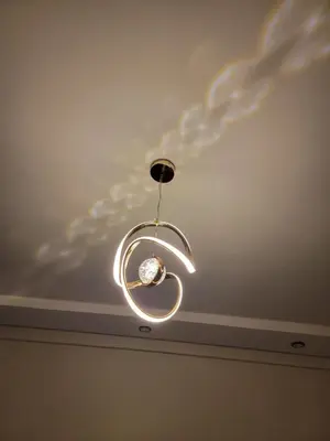 aendant light hanging from a ceiling in a room at Nour prestige Appartement Piscine free Parking in Marrakech