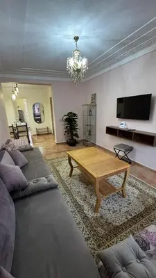 a living room with a couch and a coffee table at Appartement 2 chambres et 1 salon récemment rénové in Marrakech