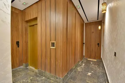 a hallway with wood paneled walls and a door at Studio luxueux - centre ville in Marrakech